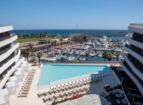 The main pool overlooking the marina at SLS Barcelona