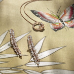 These luxurious jewels truly come alive in front of vibrant blossoms, hand-embroidered fruits, and gilded birds