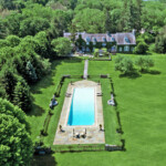 This Westchester County mansion features climate-controlled stables, an 18-seat home theater and an absolutely must-see pool